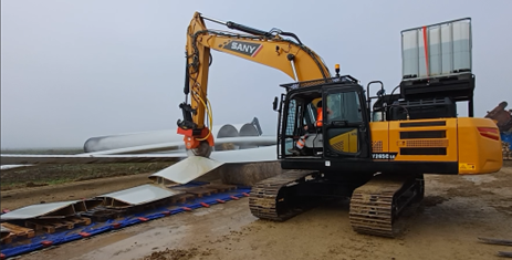 Excavator cutting wind blade.