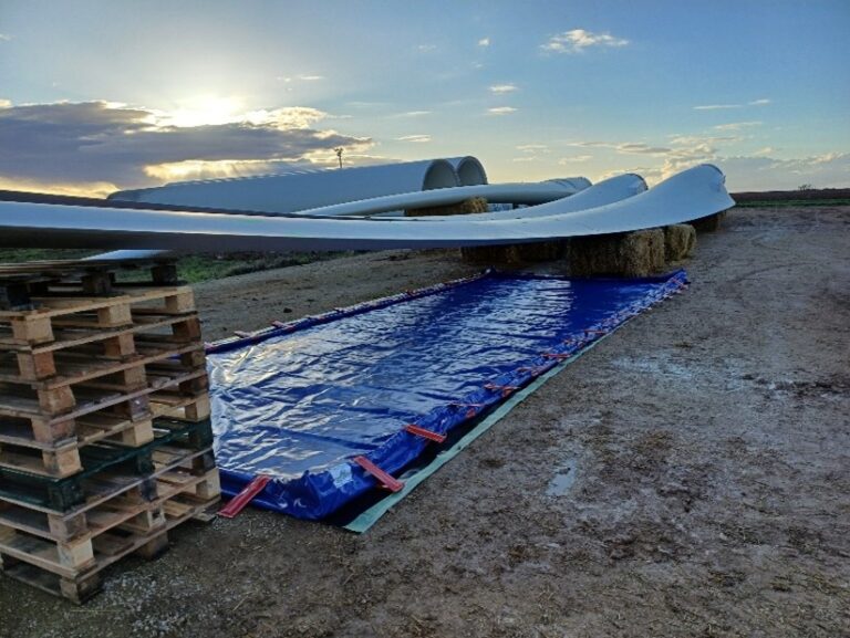 Wind turbine blades lying on ground.