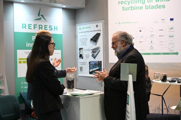 People talking on an exhibition booth.