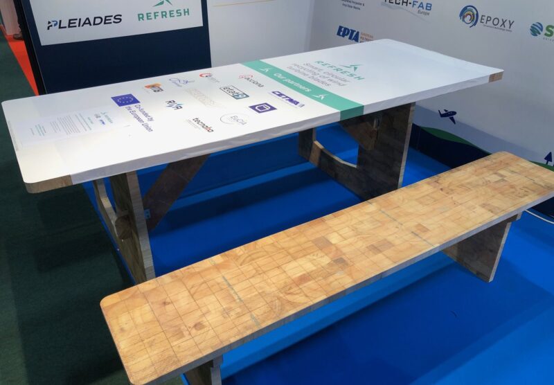 Picnic table with white top.