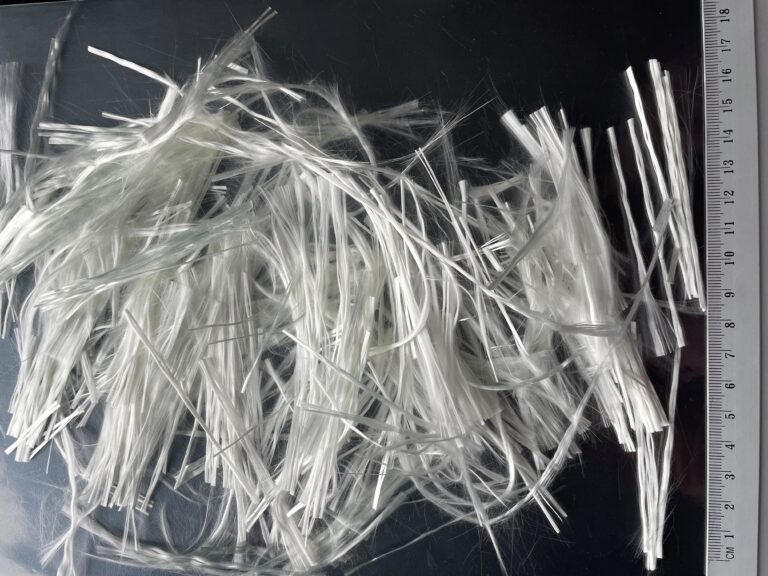 Strands of white material with a ruler on the right.